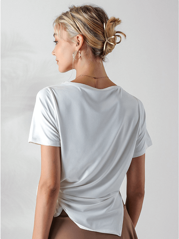 Back view of a woman wearing a white loose hollow-out shoulders t-shirt, ideal for running and yoga, showcasing breathable fabric.